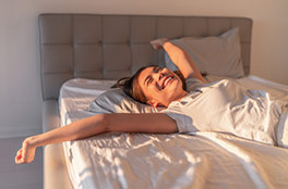 Woman waking up in bed